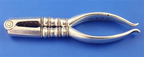A pair of George V silver nut crackers by Collins & Co, (Dryad Art Metal Works), 2.5 oz.